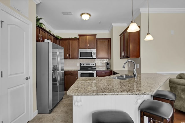 8855 Radcliff Dr NW Unit 50B, Calabash, NC 28467 - kitchen with appliances with stainless steel finishes, a peninsula, light stone counters, ornamental molding, and tasteful backsplash