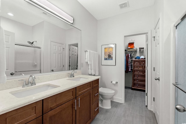 310 Lockerbie Ct Unit 1057, Myrtle Beach, SC 29577 - full bathroom featuring a shower stall, double vanity, tile patterned flooring, and a spacious closet
