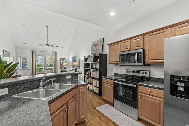 310 Lockerbie Ct Unit 1057, Myrtle Beach, SC 29577 - kitchen featuring stainless steel appliances, vaulted ceiling, dark countertops, wood finished floors, and ceiling fan