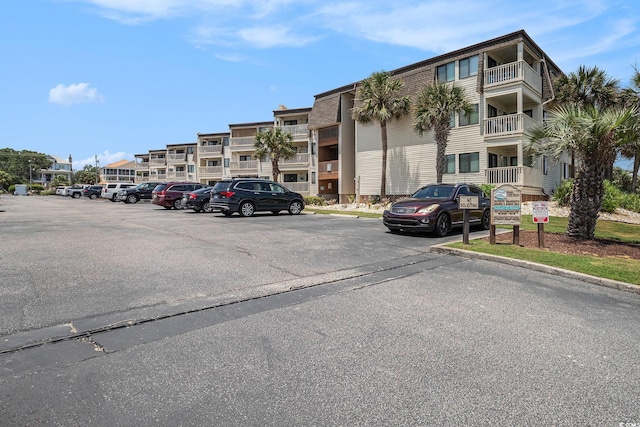 5601 N Ocean Blvd Unit E-113, Myrtle Beach, SC 29577 - view of building exterior with uncovered parking