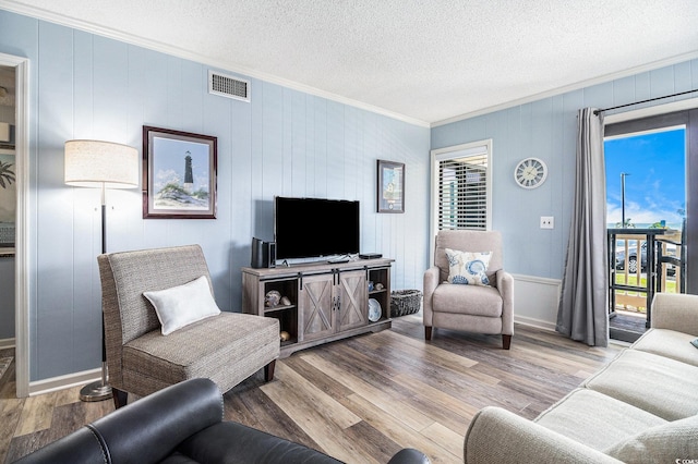 5601 N Ocean Blvd Unit E-113, Myrtle Beach, SC 29577 - living area featuring crown molding, wood finished floors, and a textured ceiling