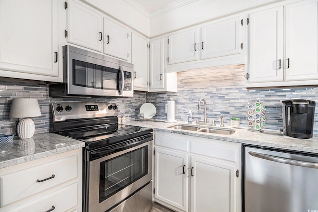 5601 N Ocean Blvd Unit E-113, Myrtle Beach, SC 29577 - kitchen with stainless steel appliances, crown molding, white cabinetry, and tasteful backsplash