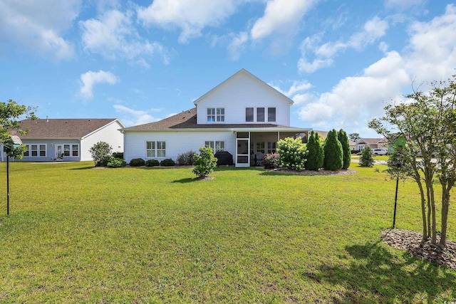 932 Abernathy Pl, Surfside Beach, SC 29575 - rear view of property with a sunroom and a yard