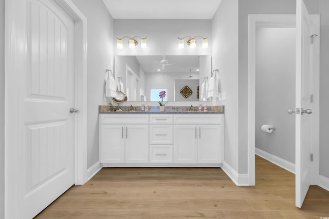 932 Abernathy Pl, Surfside Beach, SC 29575 - full bathroom with double vanity, a ceiling fan, and wood finished floors