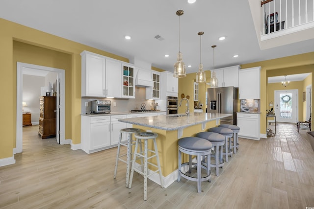 932 Abernathy Pl, Surfside Beach, SC 29575 - kitchen with stainless steel appliances, light wood-style flooring, tasteful backsplash, and recessed lighting