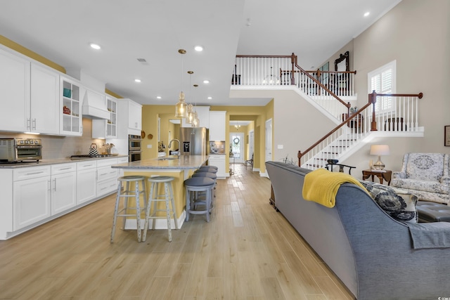 932 Abernathy Pl, Surfside Beach, SC 29575 - living room featuring light wood-style flooring, stairway, and recessed lighting