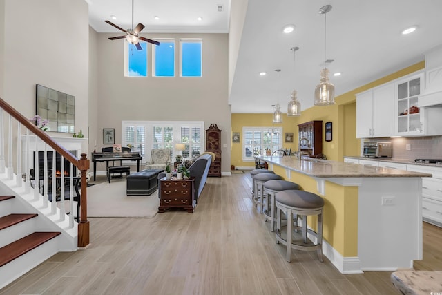 932 Abernathy Pl, Surfside Beach, SC 29575 - kitchen featuring ceiling fan, light stone countertops, healthy amount of natural light, a breakfast bar, and recessed lighting