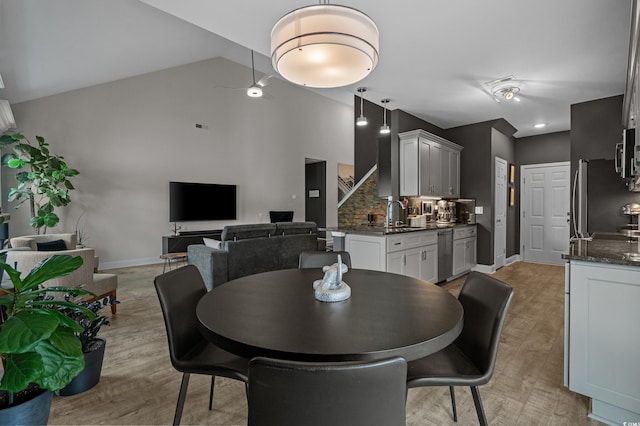 752 Hobonny Loop, Longs, SC 29568 - dining space with light wood-type flooring, high vaulted ceiling, and stairs