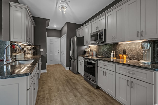 752 Hobonny Loop, Longs, SC 29568 - kitchen with stainless steel appliances, wood finished floors, decorative backsplash, recessed lighting, and dark stone counters