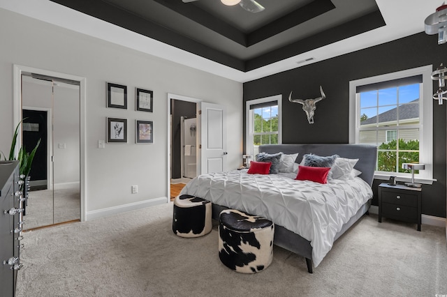 752 Hobonny Loop, Longs, SC 29568 - bedroom with a tray ceiling, light colored carpet, and ensuite bathroom