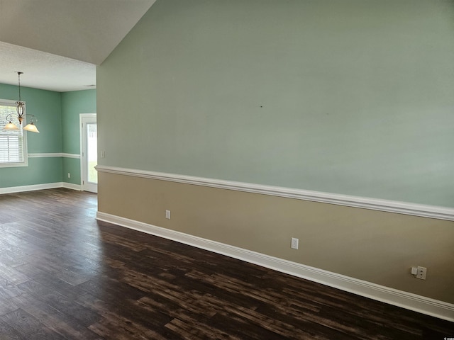 1028 Cherry Tree Ln, North Myrtle Beach, SC 29582 - unfurnished room with dark wood-style flooring, a chandelier, and vaulted ceiling