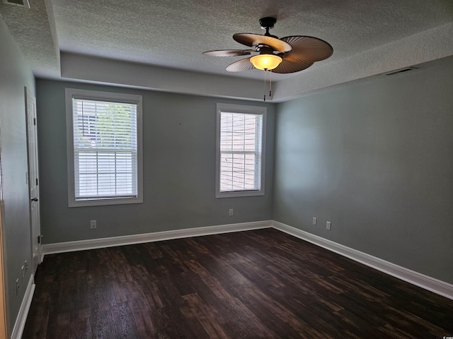 1028 Cherry Tree Ln, North Myrtle Beach, SC 29582 - unfurnished room with a textured ceiling, dark wood-style flooring, ceiling fan, and a raised ceiling