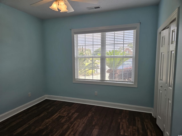 1028 Cherry Tree Ln, North Myrtle Beach, SC 29582 - unfurnished bedroom with dark wood-style flooring, ceiling fan, and a closet