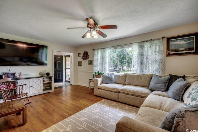 4189 Schoolhouse Cir, Little River, SC 29566 - living room with a ceiling fan, light wood finished floors, and a textured ceiling