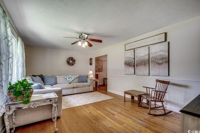 4189 Schoolhouse Cir, Little River, SC 29566 - living room with wood finished floors, a ceiling fan, and a textured ceiling