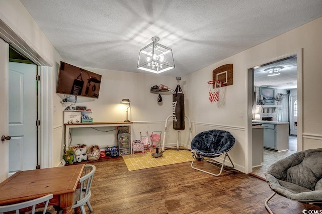 4189 Schoolhouse Cir, Little River, SC 29566 - dining space with wood finished floors, a textured ceiling, and a chandelier