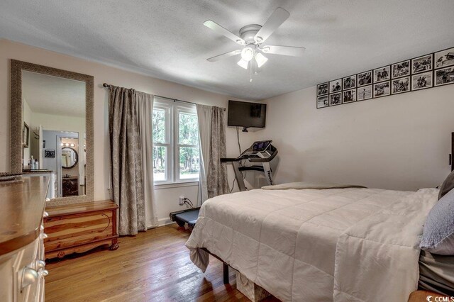4189 Schoolhouse Cir, Little River, SC 29566 - bedroom with wood finished floors and ceiling fan