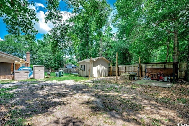 4189 Schoolhouse Cir, Little River, SC 29566 - fenced backyard featuring a storage shed and view of wooded area
