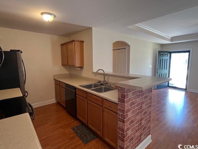 298 Weyburn St, Myrtle Beach, SC 29579 - kitchen with black dishwasher, freestanding refrigerator, wood finished floors, and arched walkways