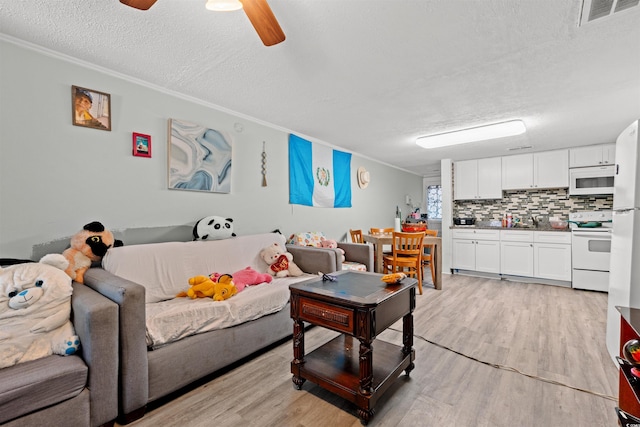 304 1st Ave N, Myrtle Beach, SC 29577 - living room with a textured ceiling, crown molding, light wood-type flooring, and a ceiling fan