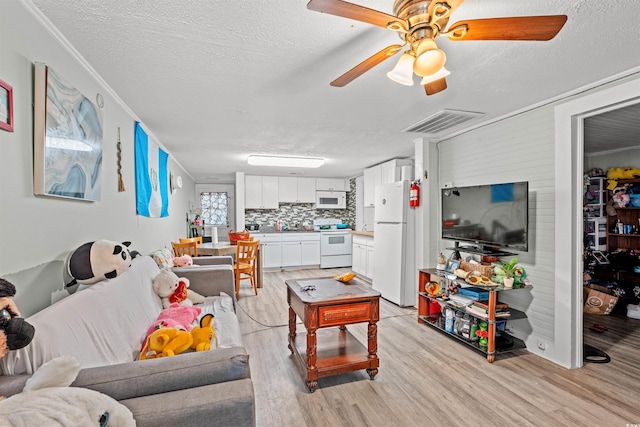304 1st Ave N, Myrtle Beach, SC 29577 - living room with light wood-style floors, a textured ceiling, and ceiling fan