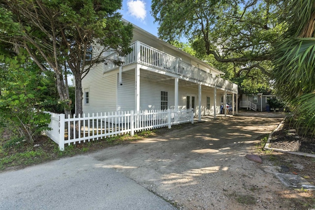 304 1st Ave N, Myrtle Beach, SC 29577 - view of side of home featuring driveway and a balcony