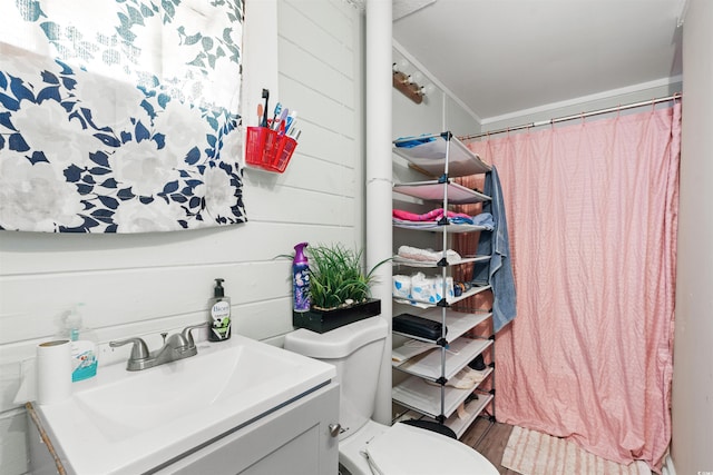 304 1st Ave N, Myrtle Beach, SC 29577 - bathroom with vanity, a shower with shower curtain, and wooden walls