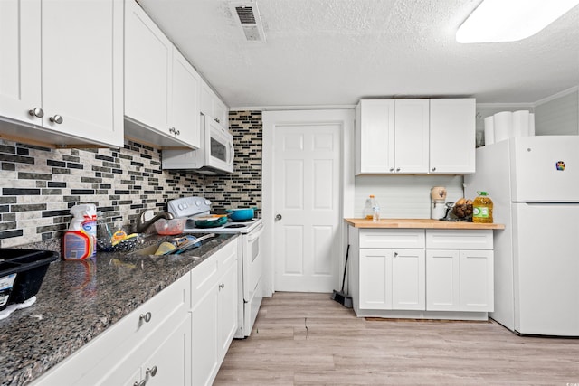 304 1st Ave N, Myrtle Beach, SC 29577 - kitchen featuring white appliances, white cabinetry, decorative backsplash, a textured ceiling, and light wood-type flooring