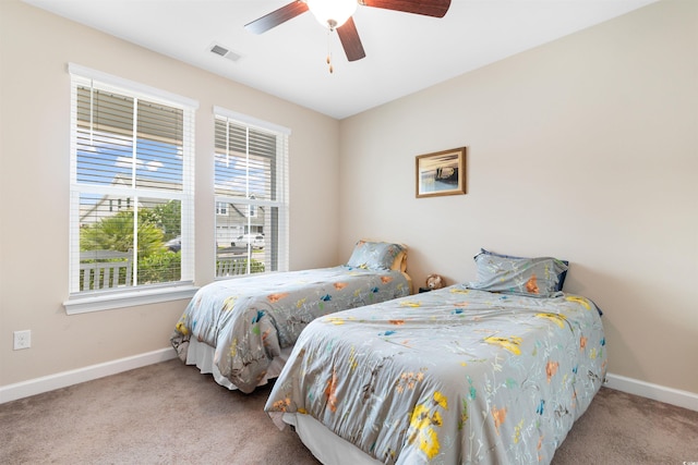 413 Goldenrod Cir Unit 2B, Little River, SC 29566 - bedroom with carpet floors, multiple windows, and ceiling fan