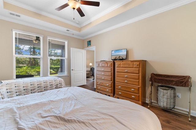 413 Goldenrod Cir Unit 2B, Little River, SC 29566 - bedroom featuring wood finished floors, ornamental molding, a tray ceiling, and ceiling fan