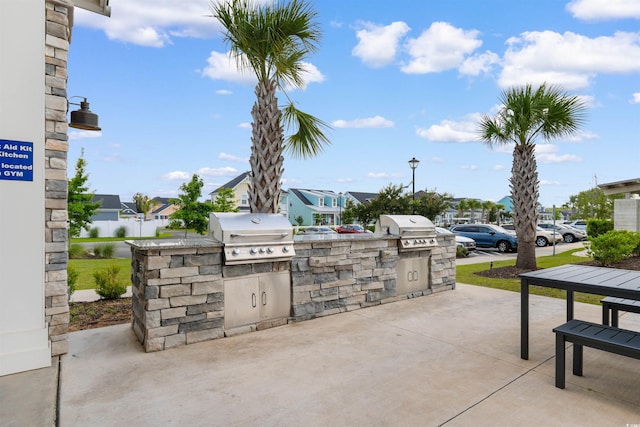 413 Goldenrod Cir Unit 2B, Little River, SC 29566 - view of patio / terrace featuring an outdoor kitchen and a residential view