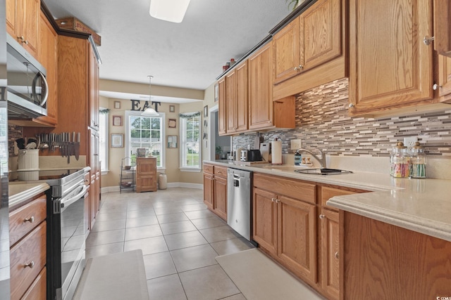 232 White Water Loop, Conway, SC 29526 - kitchen with appliances with stainless steel finishes, backsplash, light countertops, light tile patterned flooring, and pendant lighting