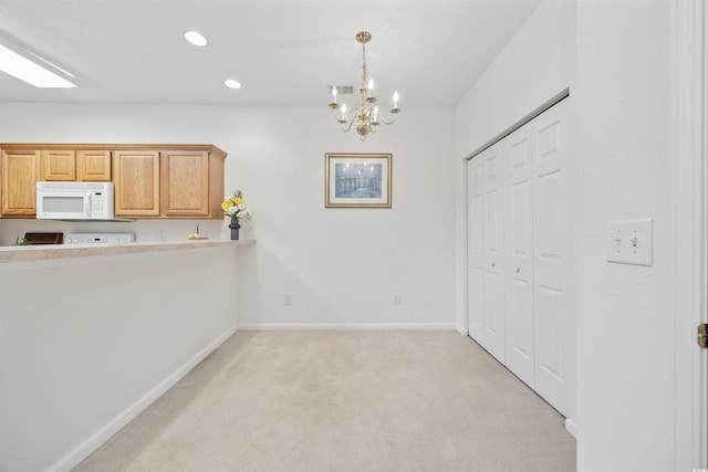 155 Chenoa Dr Unit D, Murrells Inlet, SC 29576 - kitchen featuring white microwave, light colored carpet, a chandelier, light countertops, and recessed lighting