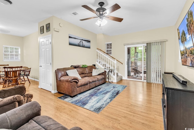 3969 Murrells Inlet Rd, Murrells Inlet, SC 29576 - living area with light wood-type flooring, stairway, and a ceiling fan