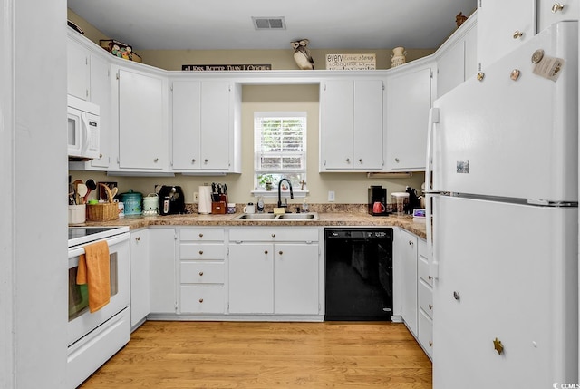 3969 Murrells Inlet Rd, Murrells Inlet, SC 29576 - kitchen featuring white appliances, light countertops, white cabinetry, and light wood-style floors