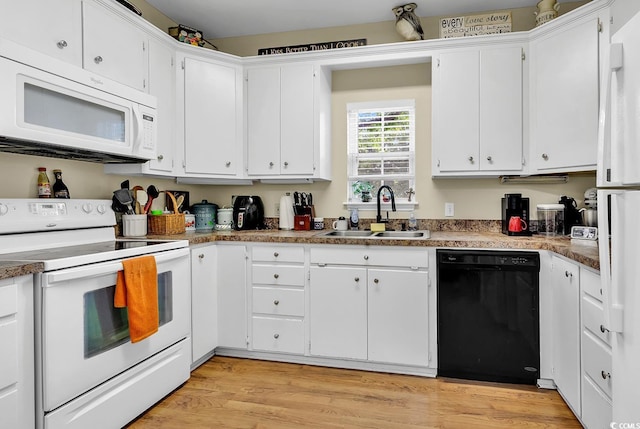 3969 Murrells Inlet Rd, Murrells Inlet, SC 29576 - kitchen with white appliances, white cabinetry, and light wood-type flooring