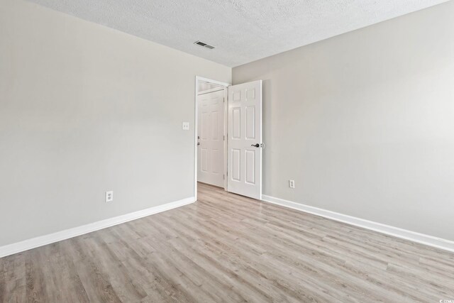 4049 Fairway Lakes Dr Unit 4049, Myrtle Beach, SC 29577 - empty room with light wood-style floors and a textured ceiling