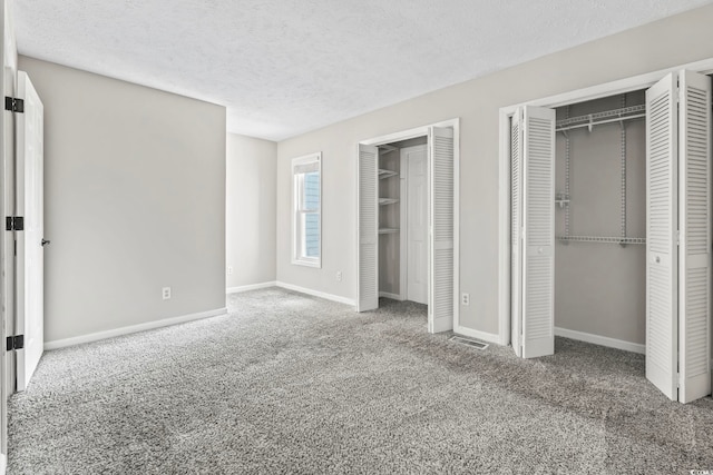 4049 Fairway Lakes Dr Unit 4049, Myrtle Beach, SC 29577 - unfurnished bedroom featuring multiple closets, carpet floors, and a textured ceiling