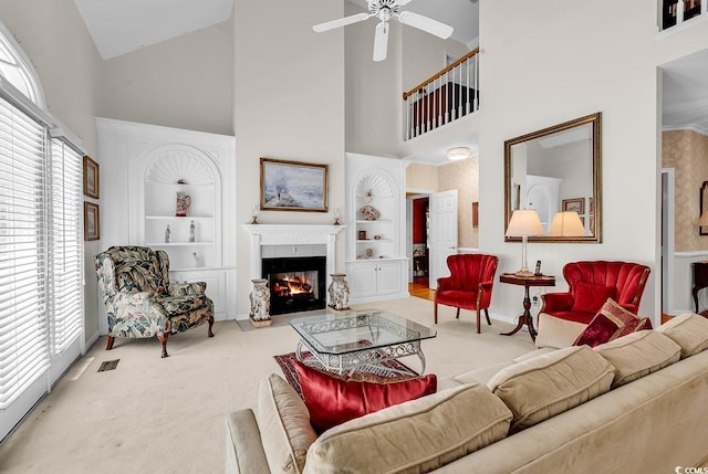 241 Black Duck Rd, Pawleys Island, SC 29585 - carpeted living area featuring high vaulted ceiling, built in features, a ceiling fan, and a glass covered fireplace