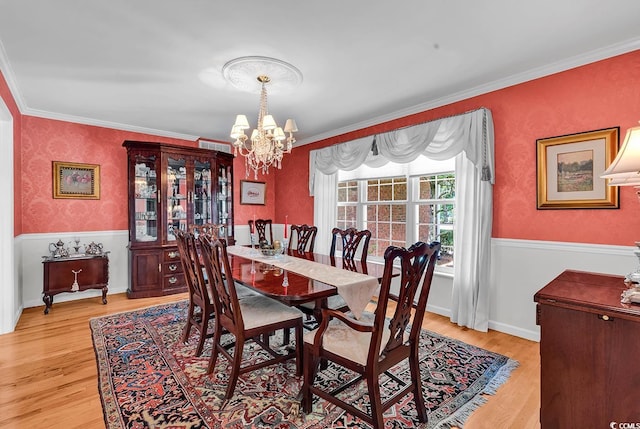 241 Black Duck Rd, Pawleys Island, SC 29585 - dining area with a chandelier, light wood-type flooring, and ornamental molding