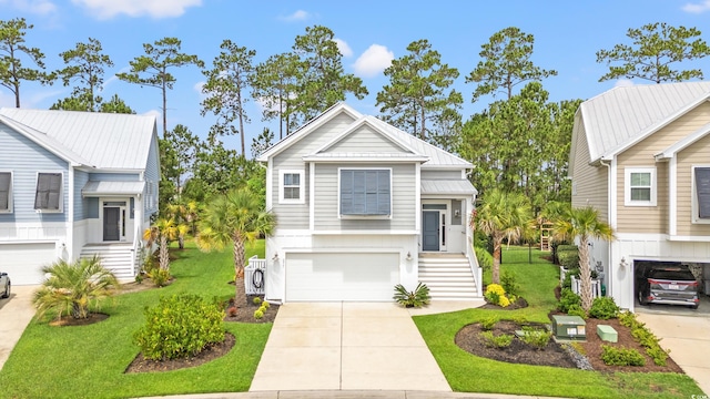277 Splendor Cir, Murrells Inlet, SC 29576 - view of front of house featuring a garage, concrete driveway, a front lawn, and stairs
