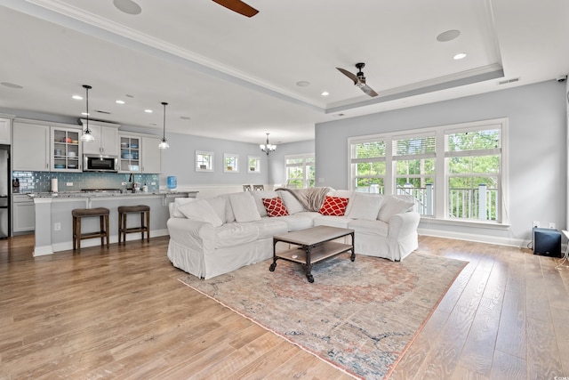 277 Splendor Cir, Murrells Inlet, SC 29576 - living room featuring ceiling fan, light wood-style flooring, a raised ceiling, recessed lighting, and a chandelier