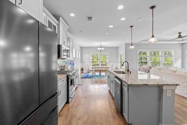 277 Splendor Cir, Murrells Inlet, SC 29576 - kitchen with stainless steel appliances, white cabinetry, light wood-style flooring, recessed lighting, and an island with sink