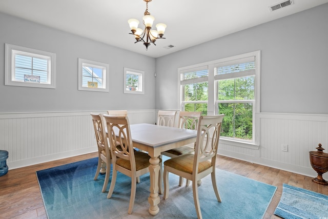 277 Splendor Cir, Murrells Inlet, SC 29576 - dining space featuring a wainscoted wall, a chandelier, and wood finished floors