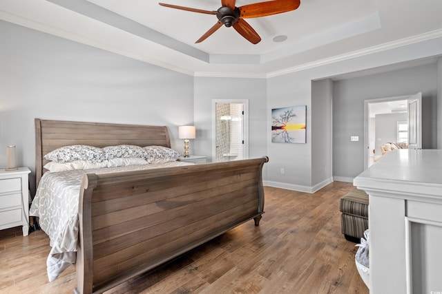 277 Splendor Cir, Murrells Inlet, SC 29576 - bedroom featuring a raised ceiling, light wood-style floors, a ceiling fan, crown molding, and connected bathroom