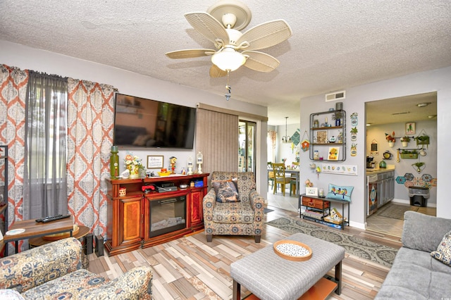 1025 Plantation Dr Unit 2413/2414, Little River, SC 29566 - living area with a textured ceiling and a ceiling fan