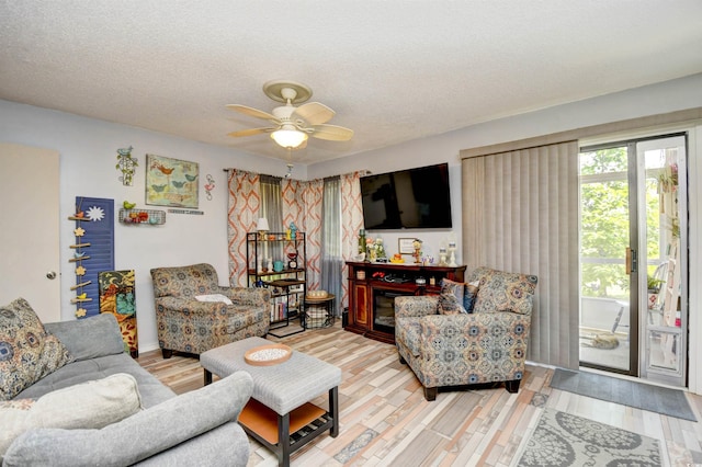 1025 Plantation Dr Unit 2413/2414, Little River, SC 29566 - living area featuring a textured ceiling, light wood-style flooring, and ceiling fan