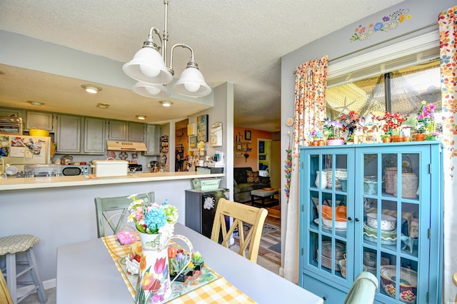 1025 Plantation Dr Unit 2413/2414, Little River, SC 29566 - dining space with a textured ceiling and a chandelier