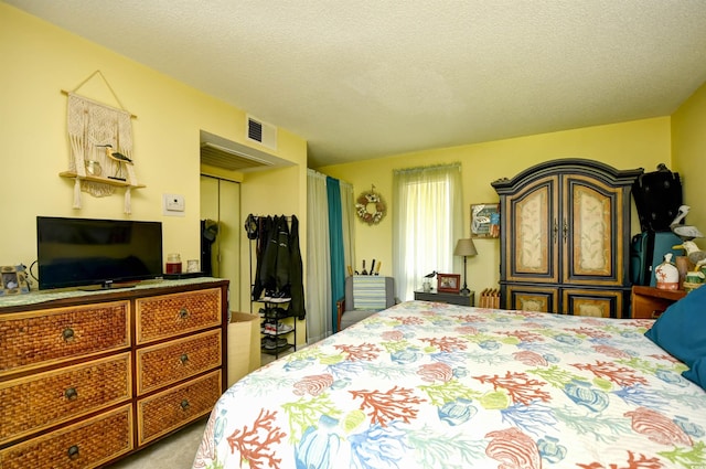 1025 Plantation Dr Unit 2413/2414, Little River, SC 29566 - carpeted bedroom featuring a closet and a textured ceiling