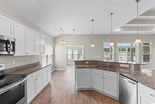 347 Leste Rd, Myrtle Beach, SC 29588 - kitchen with appliances with stainless steel finishes, wood finished floors, white cabinetry, hanging light fixtures, and lofted ceiling